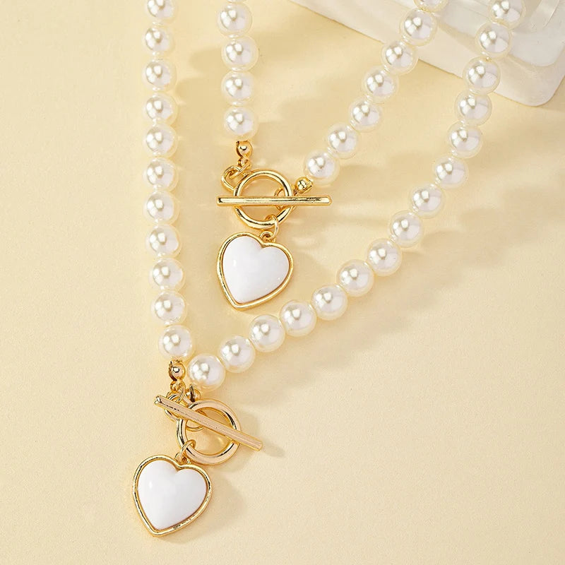 Set di gioielli con bracciale e collana di perle imitazione da 2 pezzi. Elegante collare con perline di colore naturale con ciondolo color perla per ragazza