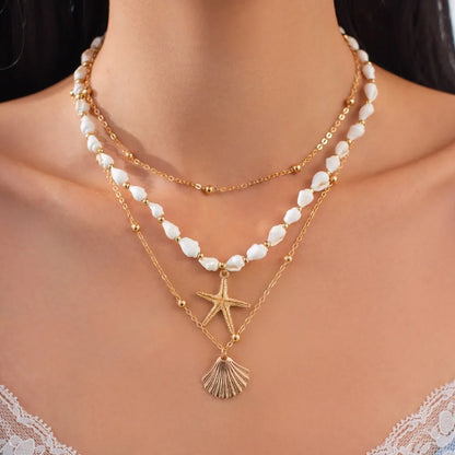 Collana con ciondolo stella marina con perline di riso bohémien per donna, fatta a mano, perla d'imitazione, girocollo con perline colorate, gioielli da spiaggia estiva