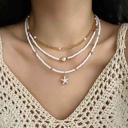 Collana con ciondolo stella marina con perline di riso bohémien per donna, fatta a mano, perla d'imitazione, girocollo con perline colorate, gioielli da spiaggia estiva