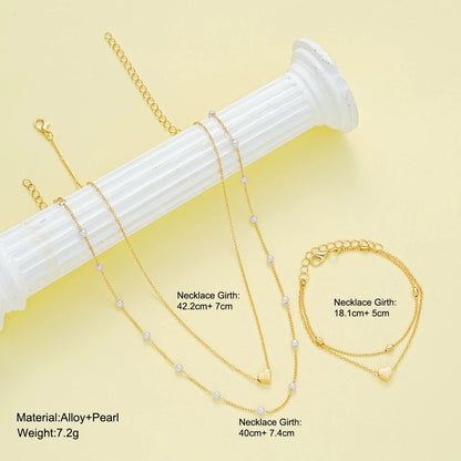Set di gioielli con cuore di perle imitazione moda per donna Set di braccialetti con collana di perline rotonde color oro argento Set di accessori per l'uso quotidiano