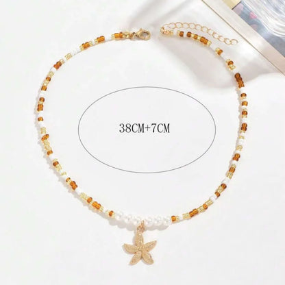 Collana con ciondolo stella marina con perline di riso bohémien per donna, fatta a mano, perla d'imitazione, girocollo con perline colorate, gioielli da spiaggia estiva