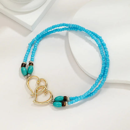 Cavigliera con perline a strati della Boemia per le donne Bracciale alla caviglia con ciondolo a doppio cuore cavo Regalo di gioielli per le vacanze estive al mare