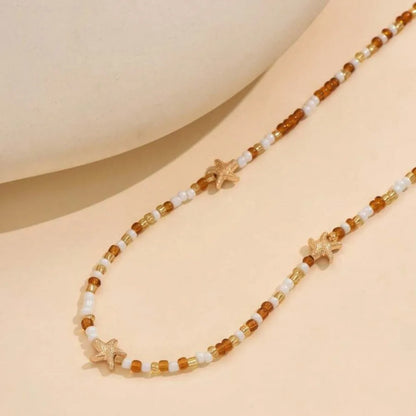 Collana con ciondolo stella marina con perline di riso bohémien per donna, fatta a mano, perla d'imitazione, girocollo con perline colorate, gioielli da spiaggia estiva